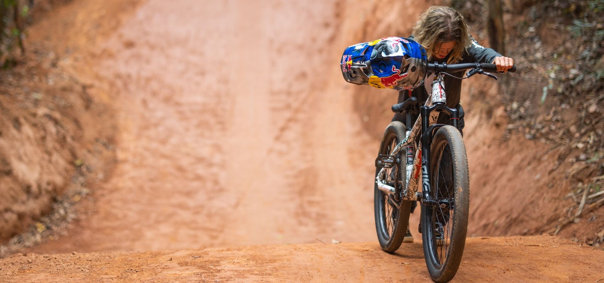 Erik Fedko pushing his bike at Crankworx Rotorua